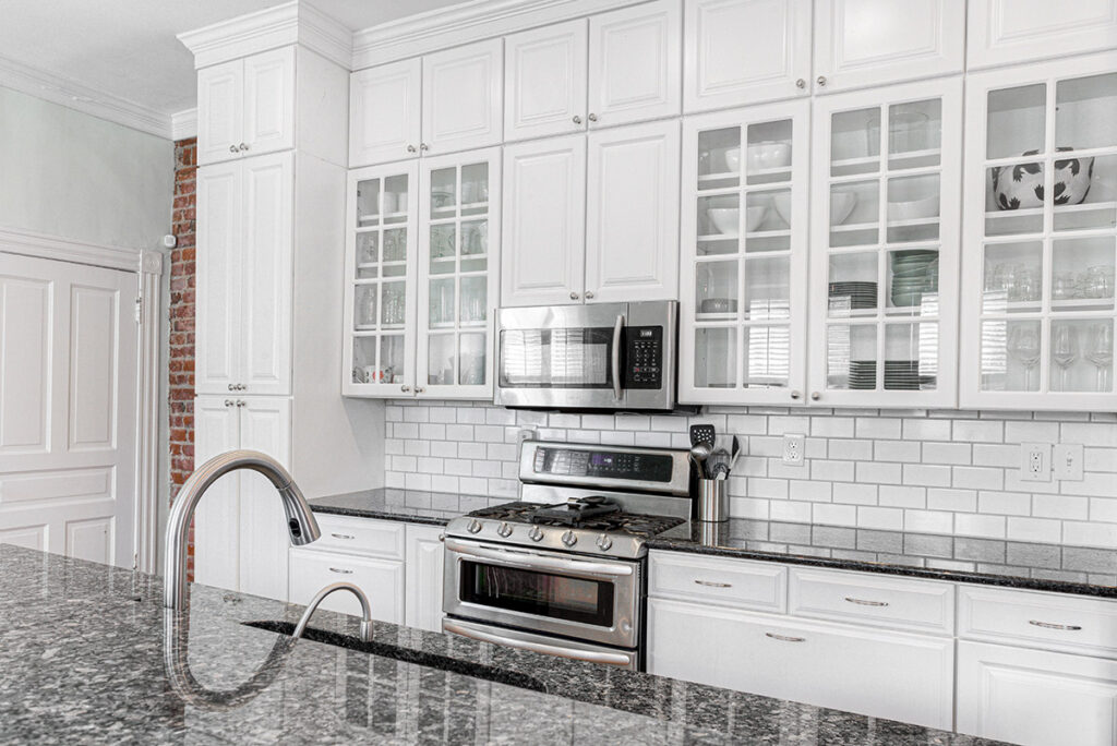 Galley Kitchen Remodeling Ideas for Condo Living in Dane County A bright modern galley kitchen with glass-front cabinetry.