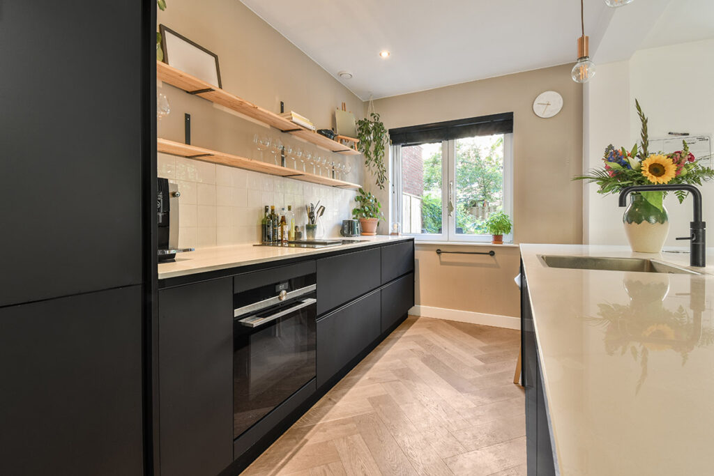 Galley Kitchen Remodeling Ideas for Condo Living in Dane County A modern galley kitchen with sleek black cabinets.